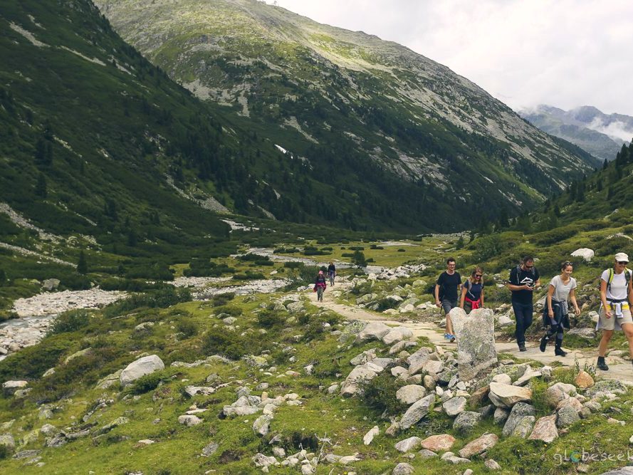 Hikers gathered at a summit cross high in the Zillertal.