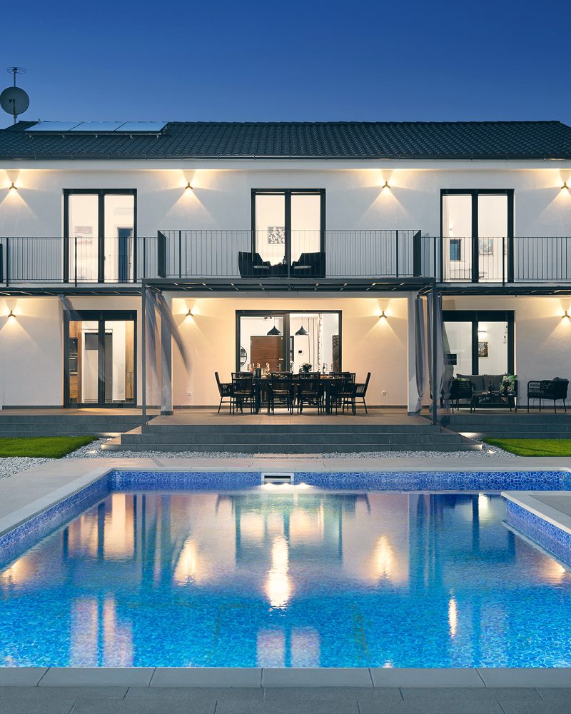 The villa's heated saltwater pool and terrace in Mediterranean light.