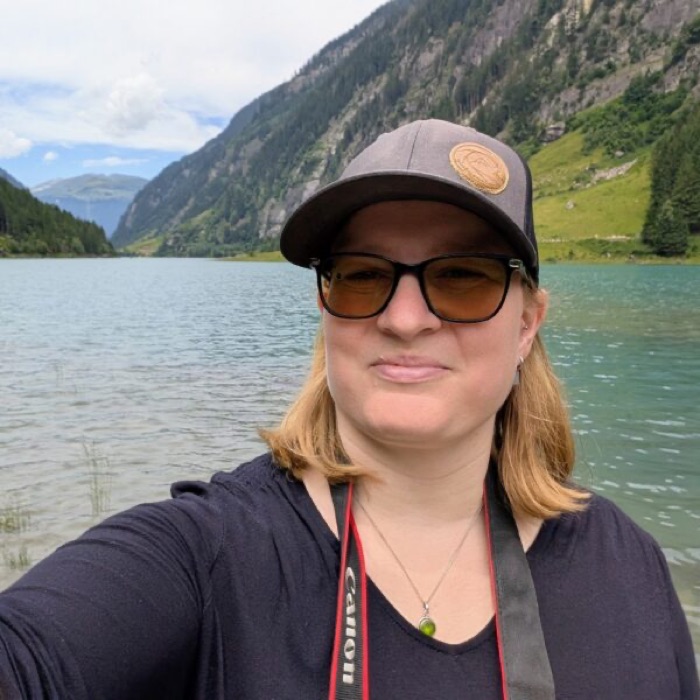 Christiane, smiling beside the water.